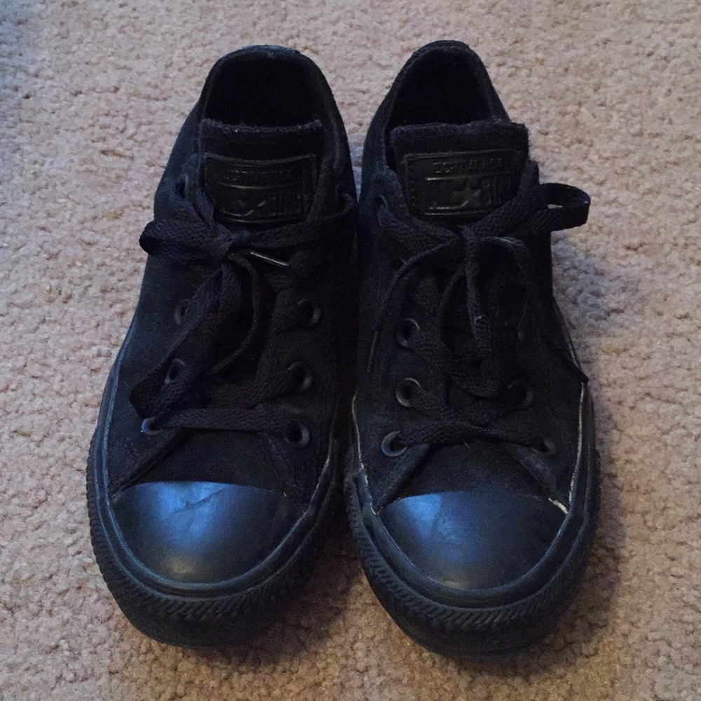 All black low-top converse shoes.